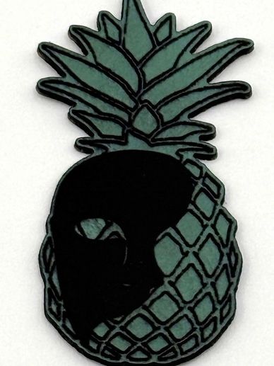 A stylized pineapple with a black mask design on one side.