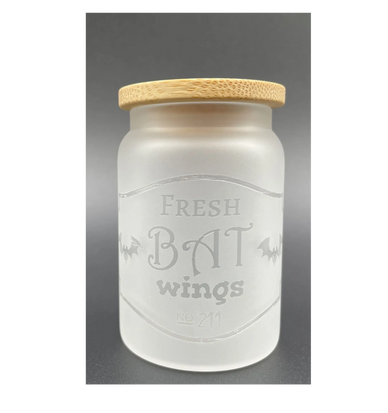 Frosted glass jar labeled 'Fresh Bat Wings' with wooden lid.