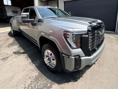 Silver heavy-duty pickup truck parked outside.