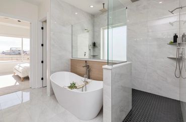 Modern bathroom with freestanding tub and walk-in shower.