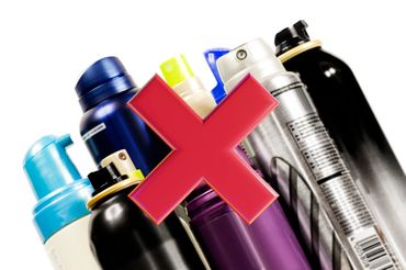 Various aerosol spray cans with a red cross over them.