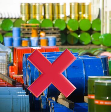 Colorful industrial barrels stacked outdoors in rows.