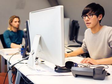 Two people working at the computer
