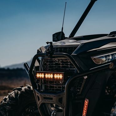 Close-up of the front grille and lights of an off-road vehicle.