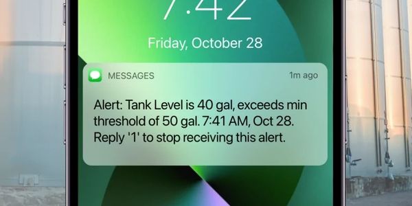 Smartphone alert notifies low tank level for timely refilling.