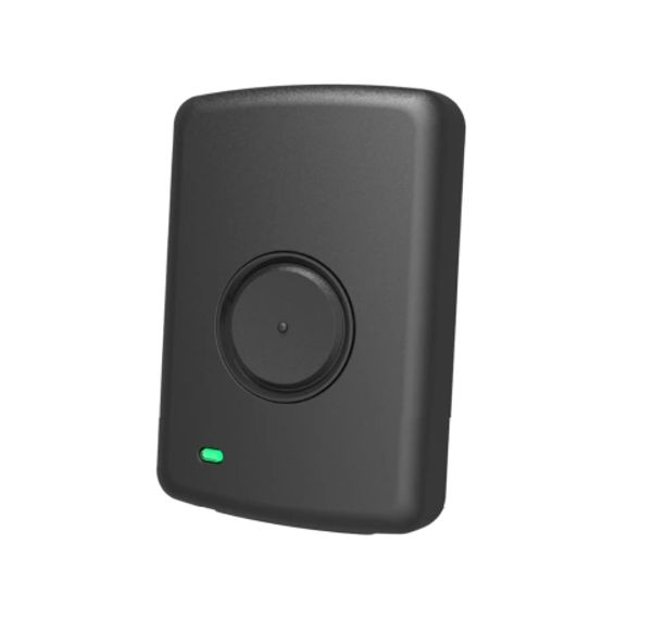 Compact black device with a circular button and a small green indicator light.