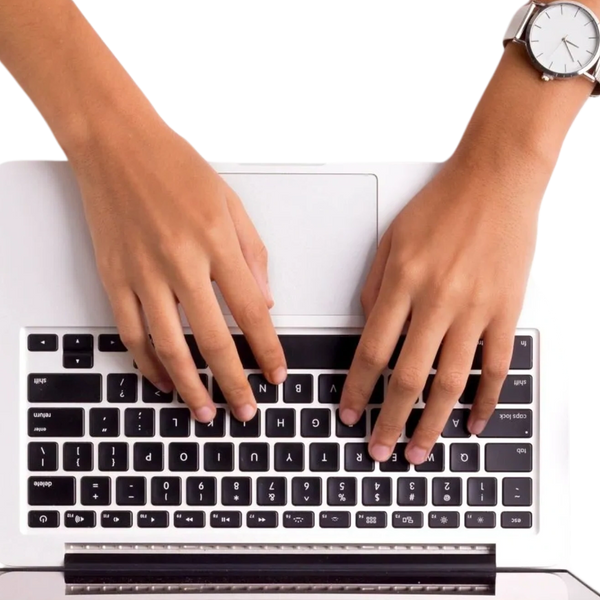 Woman typing copy on a laptop.
