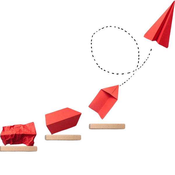 A crumbled piece of paper with an idea on it, turning into a paper airplane.