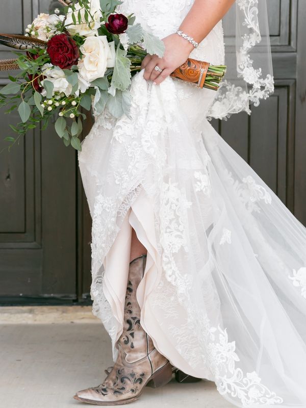 brides bouquet, wedding ring and cowboy boots