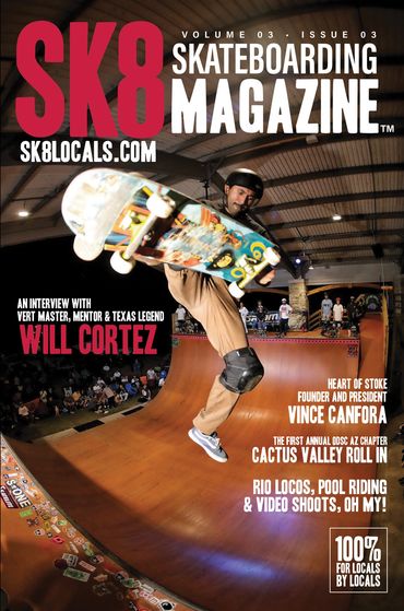 Skateboarder performing a trick on a wooden ramp at an indoor skatepark.