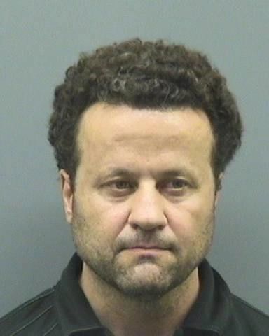 Man with curly hair and a serious expression. Monier Rahall Tampa