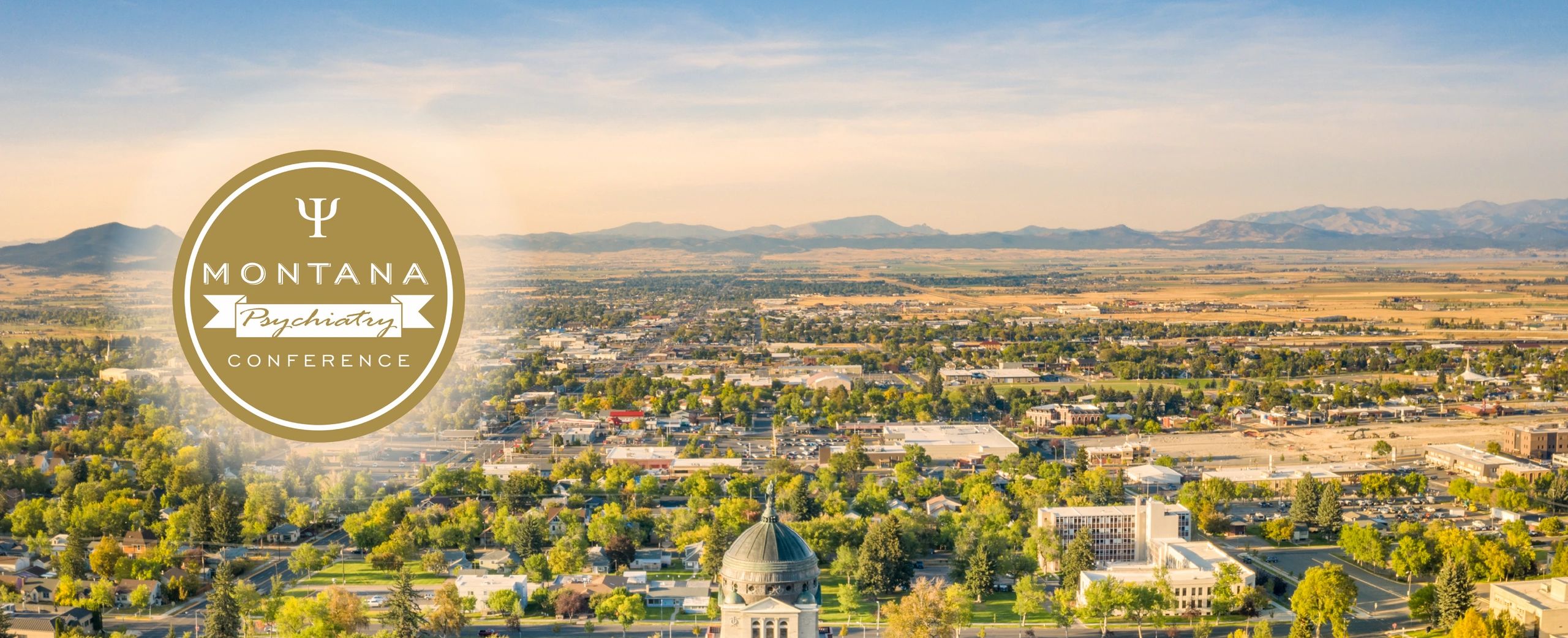 Aerial view of Helena, Montana with the capitol in the foreground and the MPC Logo