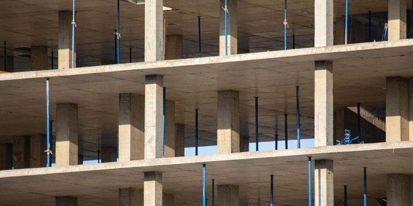 Concrete structure of a building under construction with support columns.
