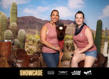 Two women posing with a stick horse in a desert-themed backdrop with cacti.