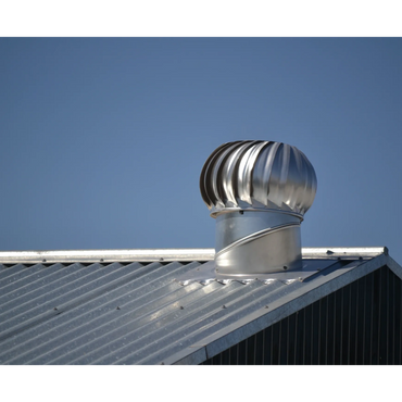 Metal roof vent against a clear blue sky.