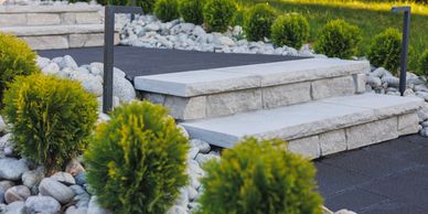Hardscapes project featuring a stone walkway with stairs and panted bushes design