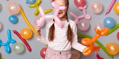 Kid with and among balloon animals