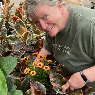 Cindy in the garden planting flowers.