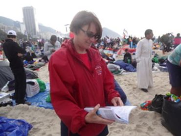 A pilgrim at World Youth Day in 2013 in Rio de Janiero using the book at the vigil.
