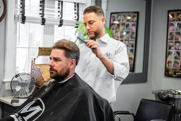 Matt combing through a client's hair