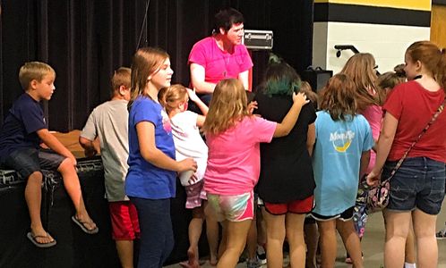 Kids crowding around Mississippi magician Bentley Burns