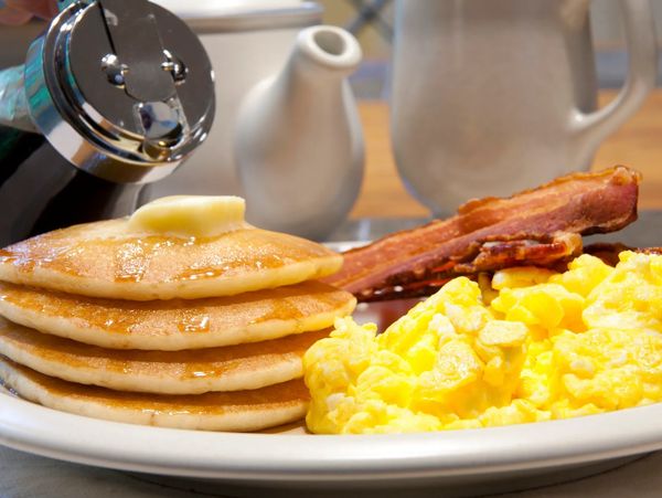 Breakfast featuring pancakes, eggs, and bacon at Sleep Inn & Suites Lancaster
