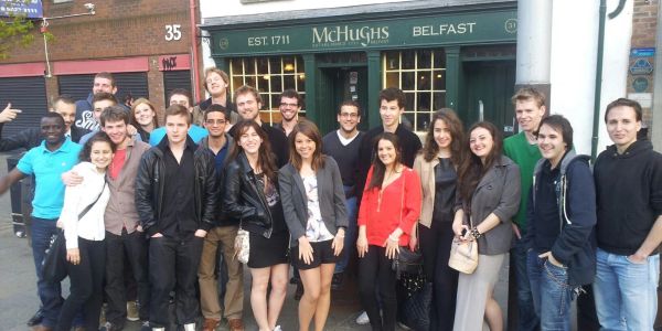 Group of young people posing outside McHughs Belfast pub.