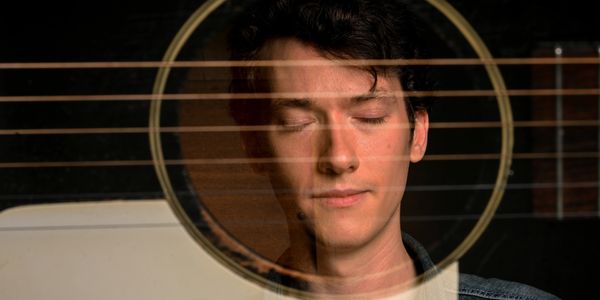 Headshot of Folk and Bluegrass Musician Mason Via