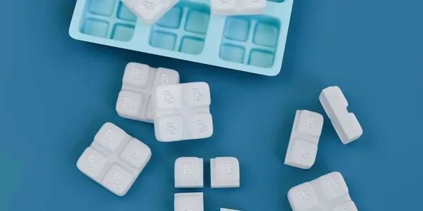White puzzle-like tablets on a blue surface.