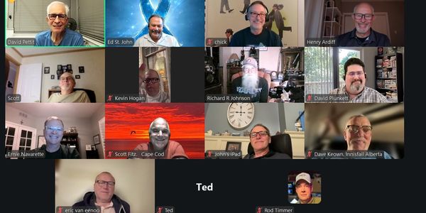 A Zoom meeting with multiple participants smiling and interacting.