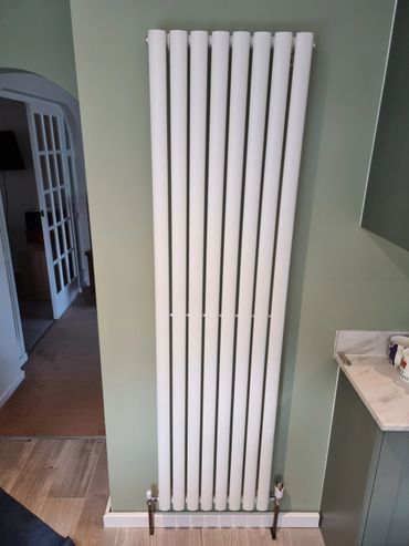 Vertical column radiator installed in kitchen