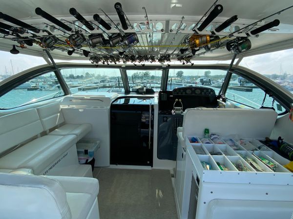 Fishing poles in storage on hard top of boat aboard the Relentless Pursuit