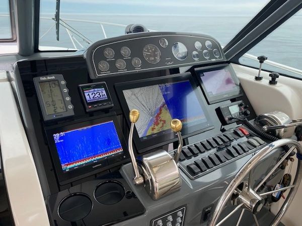 Dashboard of Relentless Pursuit charter boat featuring triple chartplotters and dual VHF radios