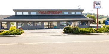 Exterior view of Waldron's store on a sunny day with clear signage.