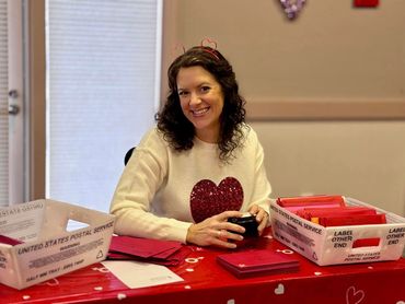 Tiffany Villavicencio stamping valentines for the City of Loveland Colorado's annual program