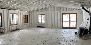 Interior of a house under construction with exposed framing and insulation.