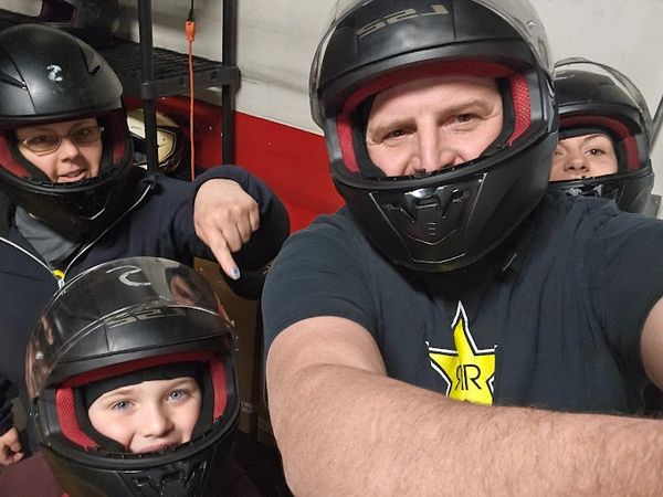 Family having a good time getting ready to race carts at Michigan's largest kart racing track.