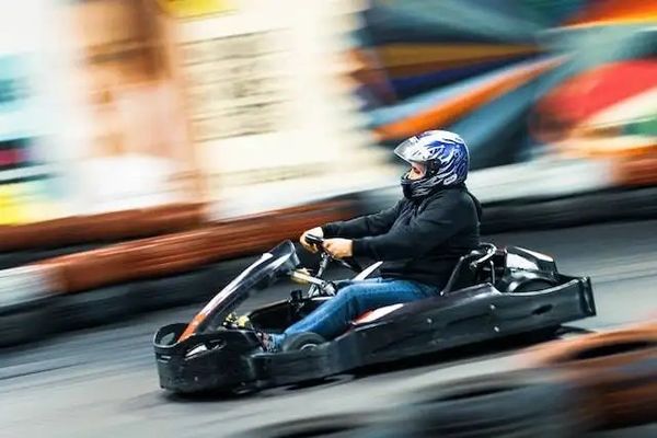 A go-kart speeds around the indoor racing track in Genesee County, Michigan. Going fast!