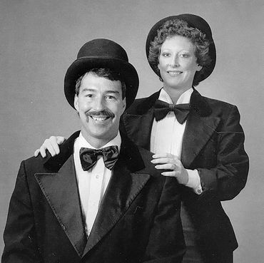 Ken and Deanna Hancock, founders of Hancock Chimney Service in traditional chimney sweep outfits