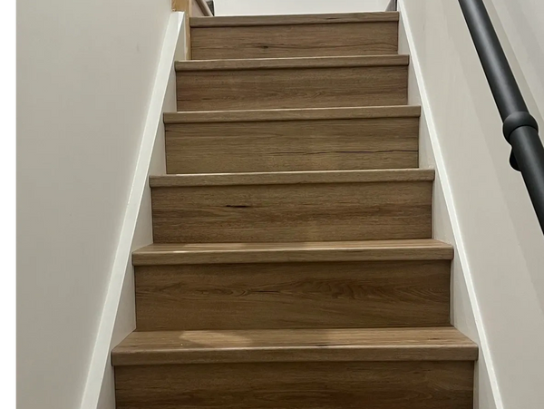 Oak LVT stair cladding covering stairs to look like real wood