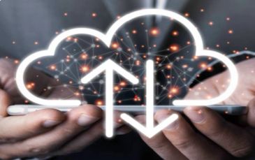 Hands holding a phone with cloud upload and download icons.
