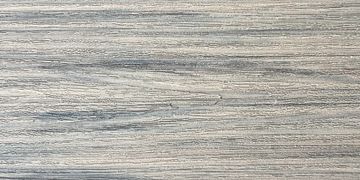 Close-up of textured light gray wooden surface.