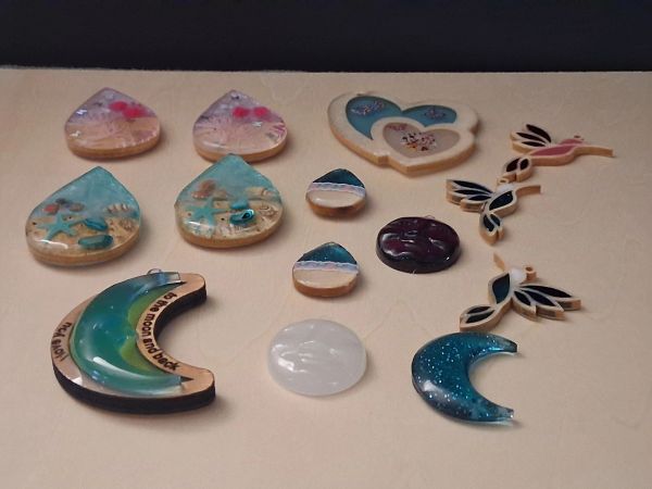 Various colorful resin pendants with sea and nature themes.