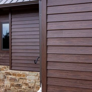 Steel siding repair and replacement with matching exterior trim on a Colorado home.
