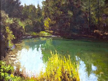 Sunny river with green foliage.