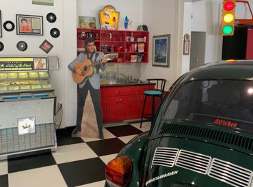 Elvis cutout standing next to jukebox