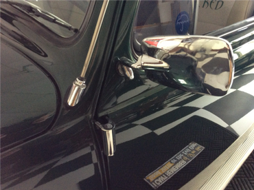 side mirror on green Volkswagen