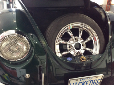 Chrome wheel with tire in VW Bug