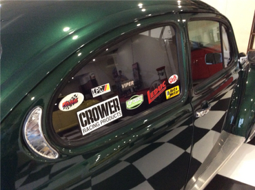 A side view of green VW Bug