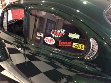 A green Volkswagen Bug side view